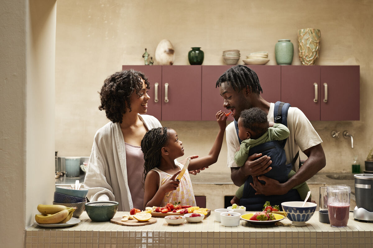 Happy family preparing healthy food together in their kitchen